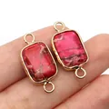 Macro view of rectangular red stone pendant connectors with dual gold loops for DIY jewelry - Red