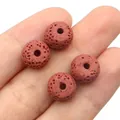 Macro detail of four reddish-brown volcanic lava stone beads with natural porous texture - Red Brown