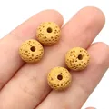 Close-up of four porous yellow lava rock beads for DIY jewelry making on white background - Earthy Yellow
