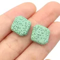 Detailed close-up of light green porous lava stone beads for DIY jewelry making - 14mm (1 Strand) / Light Green
