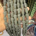 Detailed macro view of gray volcanic rock beads in unique pinecone spiral shapes - Gray (No. 11)