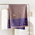 Winter floral print shawl in purple and navy blue draped on a metal hanger - 180cmx65cm / Purple