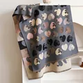 Grey and pink cashmere-like scarf featuring heart and flower patterns with tassel trim - Gray