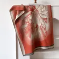 Classic orange and white daisy cashmere scarf with long tassels hanging on a white rack - 185cm / Red
