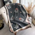 Thick cashmere-feel shawl with dark grey floral print and pink blossom fringe details - Gray