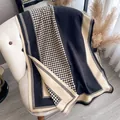 Classic black and beige houndstooth scarf with soft fringe edges and a cozy texture - Black