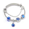 Detailed macro view of silver steel cable bracelet with blue crystal beads and heart charms - Sapphire Blue
