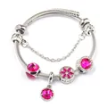 Macro detail of silver twisted cable bracelet with magenta beads and floral charm - Rose Red