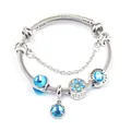 Macro view of crystal charms with Love Is Forever engraving on stainless steel bracelet - Lake Blue