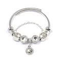 Silver stainless steel cable bracelet with crystal beads and heart pendant on white background - White