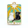 Tarot style enamel pendant featuring black and white cats with celestial sun and stars - Divine Light Twin Cats