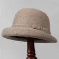 Elegant khaki wool felt cloche hat with a bow detail on a vintage wooden stand - M (56-58cm) / Mocha
