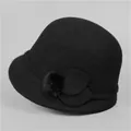 Detailed view of vintage black wool cloche hat with felt leaves and fuzzy pom pom trim - M (56-58cm) / Black