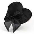 Close-up of elegant wide brim sun hat with organza bow and polka dot mesh detail - M / Black