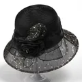 Detail of elegant black organza sun hat with sequins and a large 3D floral decoration - M / Black