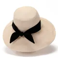 Elegant beige wide brim sun hat for women with a black ribbon bow and textured fabric - M / Beige