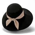 Women's wide brim sun hat in black with elegant beige ribbon bow for beach sun protection - M / Black