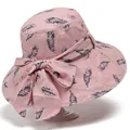 Detail of pink summer sun hat with black feather patterns and large decorative bow - M / Pink