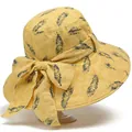 Close-up of jacquard texture and navy blue feather pattern on a yellow sun hat brim - M / Yellow