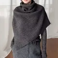 Detail of dark grey knit poncho featuring high collar design and thick ribbed texture - One Size / Dark Gray
