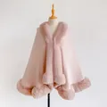 Close-up of light pink faux rabbit fur trim on a winter knit poncho cape for women - Pink