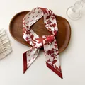 Detail of floral printed satin twilly scarf with red roses on a rustic wooden tray - 100PD-086 / 7*100cm