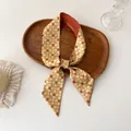 Detail of a ginger yellow long twilly scarf with white grid and red polka dots on wood - Ginger Yellow Geometric Polka Dot (C-3)