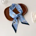 Detail of light blue floral skinny silk scarf with white lilies on a wooden tray - Sky Blue White Lily (S-19)