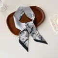 Detailed close-up of a blue floral silk skinny scarf with crane and magnolia patterns - Gray Blue Crane Floral Landscape (T-20)