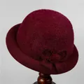 Detail view of wine red velvet bucket hat with bow accent and warm lining for elderly women - M (56-58cm) / Burgundy