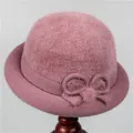 Detail of warm pink winter hat with plush faux fur top and knitted flower accent - M (56-58cm) / Pink