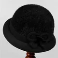 Close-up of black plush winter hat featuring a stylish bow and knitted brim detail - M (56-58cm) / Black