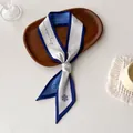 Detail of blue and white satin twilly scarf with daisy prints on wooden tray - White Blue Letter Daisy (W-23)