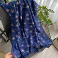 Dark blue cotton linen scarf featuring golden dandelion patterns and lightweight texture - Blue