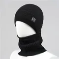 Detail of black ribbed knit beanie and neck warmer set with leather logo patch on a model - Single Hat / Black
