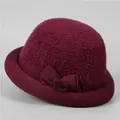 Detail of wine red winter hat featuring velvet bow decoration and plush texture - M (56-58cm) / Burgundy