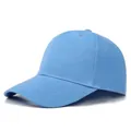 Detail view of a light blue six-panel cotton baseball cap with a standard curved brim - Adjustable / Sky Blue