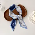 Blue and white paisley print skinny silk scarf for women displayed on a wooden tray - Blue White Paisley Letter (AD-30)