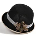 Detail of hand-woven flower ornament and beadwork on a black knit sun hat with beige trim - M (56-58cm) / Black