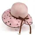 Detail of pink sun hat featuring letter print brim, brown ribbon bow and gold LOVE buckle - M (56-58cm) / Pink