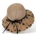 Close-up of beige sun hat mesh brim with black butterfly embroidery and silk ribbon bow - M / Khaki