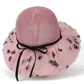 Detail of pink sun hat with wide mesh brim featuring black butterfly patterns and bow - M / Pink