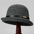Close-up of gray knit cloche hat with textured diamond pattern and black leather buckle strap - M (56-58cm) / Dark Gray