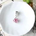 Macro shot of faceted pink crystal charm with silver large-hole bail on white tray - Pink(C6YD88)