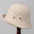 Close-up of beige wool cloche hat featuring handmade amber beads and floral rhinestone details - M (56-58cm) / Beige