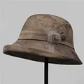 Detail view of brown marble texture felt bucket hat with bow and soft fur pom-pom detail - M (56-58cm) / Khaki