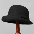Detail of a vintage black wool felt cloche hat with a rolled brim on a wooden stand - M (56-58cm) / Black