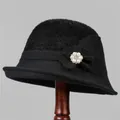 Detail of black knitted cloche hat with a white pearl and crystal flower accent - M / Black