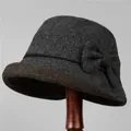 Detail van wollen cloche hoed met bruine strik op een donkergrijze vintage vilten vissershoed - M / 56-58cm / donkergrijs
