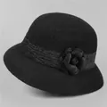Detail of a black wool cloche hat featuring a 3D handmade flower and textured ribbon trim - M / Black (Black Ribbon)